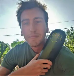 Robin, author of the blog, holding a courgette from the vegetable garden
